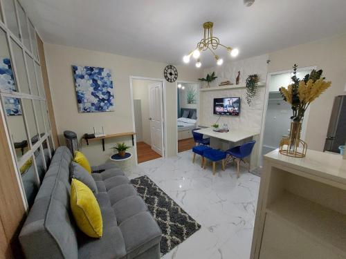 a living room with a couch and a dining room at Ann's Condo "2bedroom" in Davao City