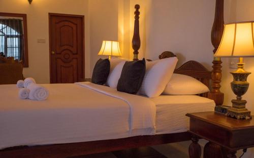 a bedroom with a bed with two towels on it at Ceylon Breeze in Kandy