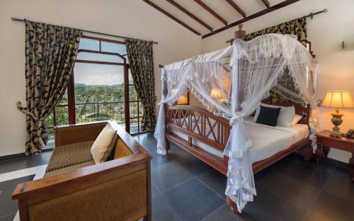 a bedroom with a canopy bed and a window at Ceylon Breeze in Kandy