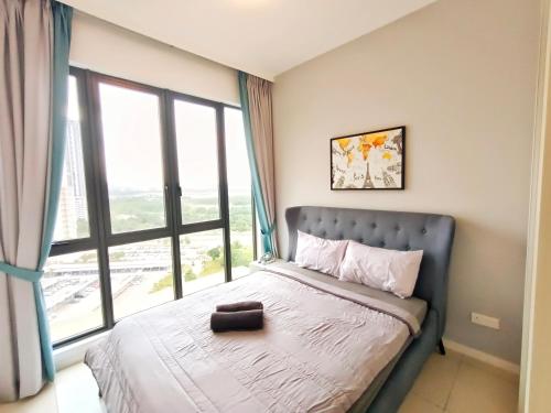 a bedroom with a bed with a large window at Medini Elysia Park , 3 min to Legoland, Netflix By Hint Homestay in Nusajaya