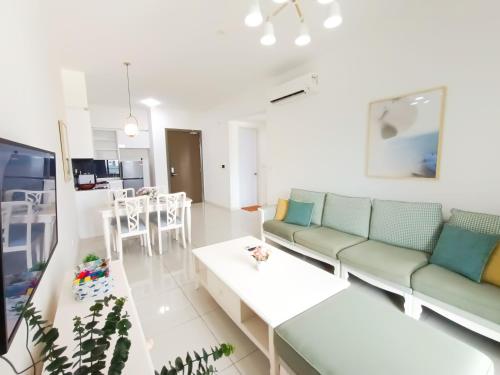 a living room with a couch and a table at Medini Elysia Park , 3 min to Legoland, Netflix By Hint Homestay in Nusajaya