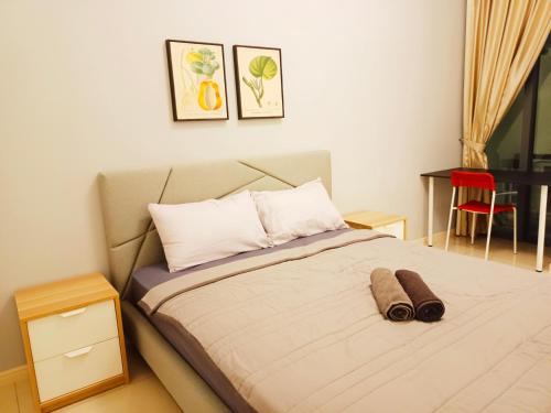 a bedroom with a bed and a red chair at Medini Elysia Park , 3 min to Legoland, Netflix By Hint Homestay in Nusajaya