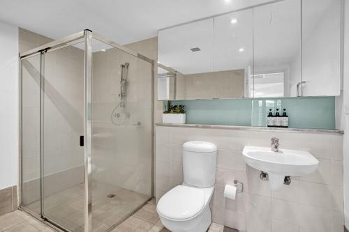 a bathroom with a toilet and a sink and a shower at Poolside at Iluka Resort Apartments in Palm Beach