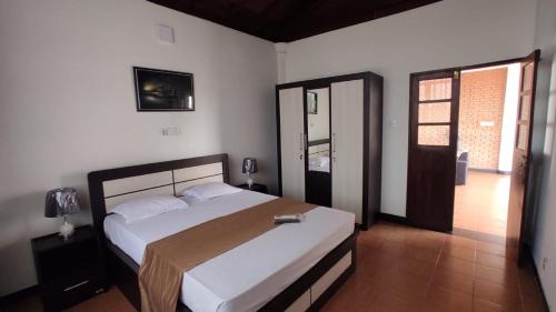 a bedroom with a large bed and a window at Melvila in Colombo