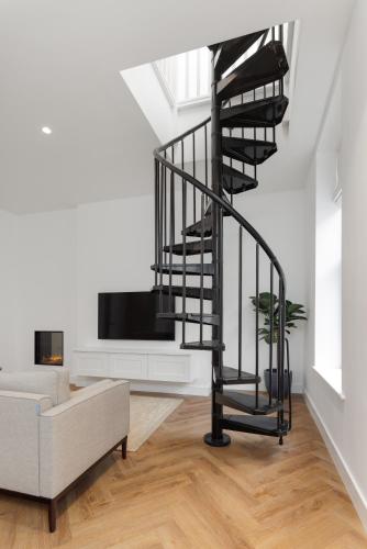 a spiral staircase in a living room with a couch at 40 Renshaw Apartments in Liverpool
