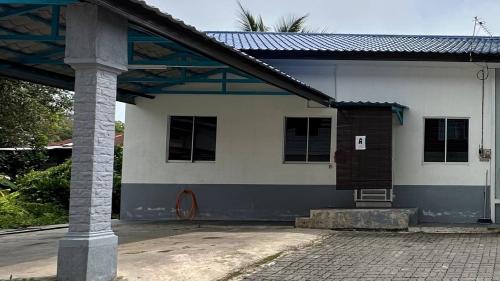 a white and blue building with a pole at IBAI COTTAGE KUALA TERENGGANU (HOMESTAY) in Kuala Terengganu