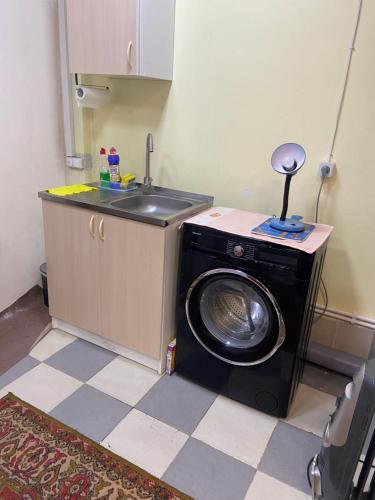a washing machine in a kitchen with a sink at Vahe’s family guests house in Yerevan