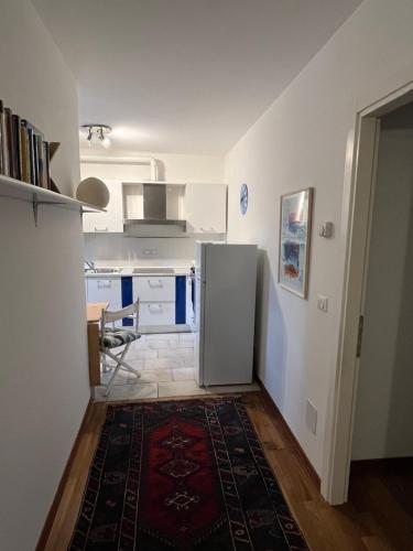 a kitchen with a refrigerator in a room at Cormòns in Cormòns