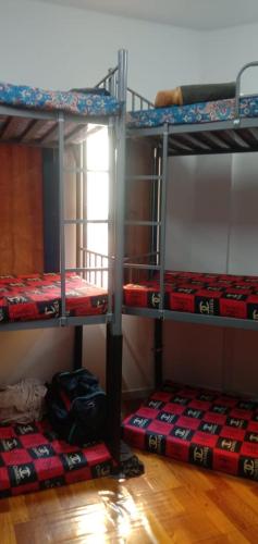 three bunk beds in a room with a window at bed space for weekly with other guests in Dubai