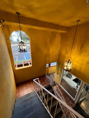 an attic hallway with stairs and a window at The Aqua Pacific Hotel in Santa Cruz