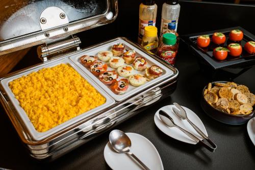 a table with a tray of food on a table at Hotel ZEMPLEN in Michalovce