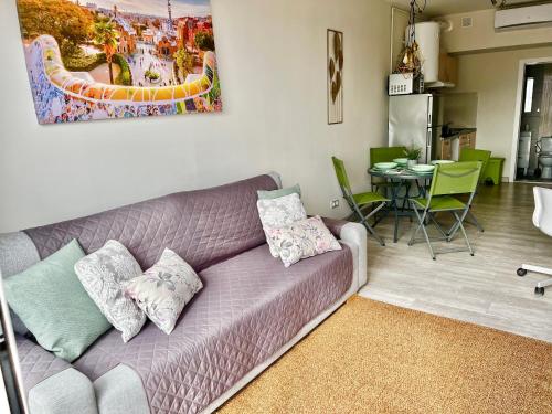 a living room with a purple couch and a table at Amazing Badalona Apartment With Terrace in Badalona