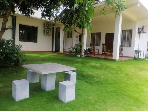 a picnic table in the yard of a house at Golden Residence in Anuradhapura
