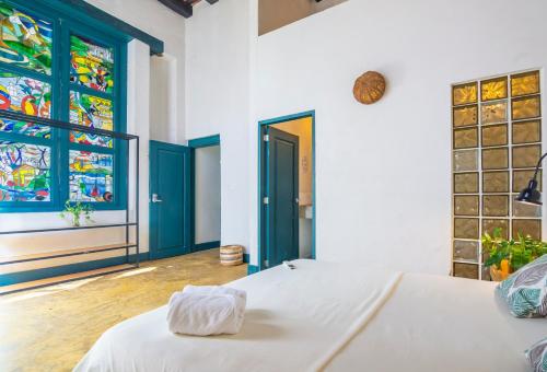 a bedroom with two beds and a stained glass window at Republica Hostel Santa Marta in Santa Marta