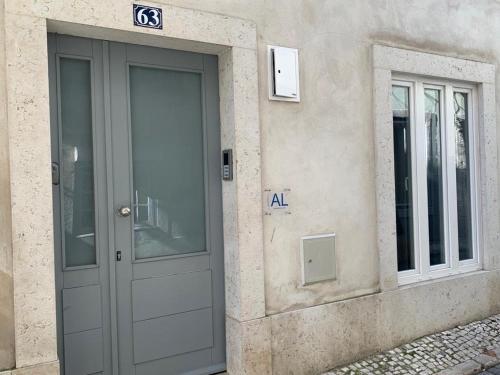 a gray door of a building with a sign on it at Garcia Place in Lisbon