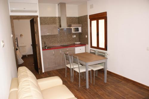 a kitchen and dining room with a table and a couch at Casa Pedro Páez in Belmonte