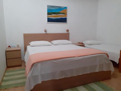 a bedroom with a bed and a painting on the wall at Ana in Zaglav