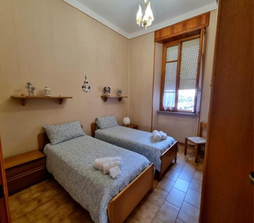 sypialnia z 2 łóżkami i oknem w obiekcie Appartamento la Playa w Cagliari