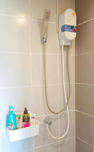 a shower with a shower head in a bathroom at Elio Del Ray in Bangkok