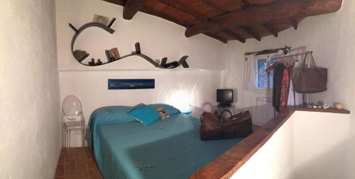 a bedroom with a blue bed in a room at Casa AZA in Roquebrune-Cap-Martin