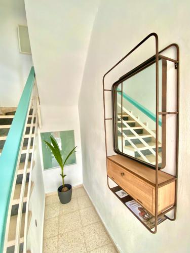 a mirror on a wall next to a staircase at Dúplex Centro Écija in Écija