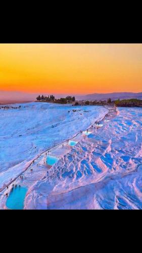 an aerial view of a beach with snow and water at OzenTurku Hotel in Pamukkale