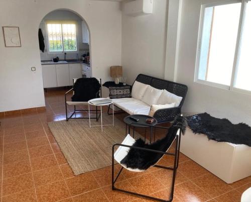 a living room with a couch and a table at Casa Elisa 3 bedrooms 2 bathrooms 4 airco's shared pool in Alcossebre