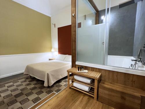 a bedroom with a bed and a tub and a sink at Bed in Spa in Palermo