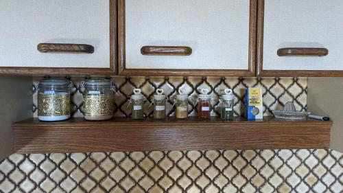 a shelf in a kitchen with jars of spices at Ursteirerhof - Familie Kerschbaumer in Palsdorf