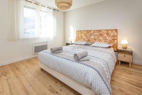 biała sypialnia z dużym łóżkiem i oknem w obiekcie Appartement Modane Wifi stationnement gratuit w mieście Modane