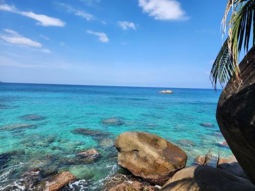 a large rock in the water next to the ocean at Marquise & Infinity villas in Glacis