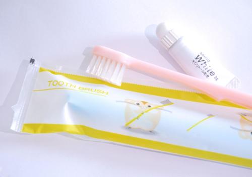 a toothbrush and toothpaste sitting on top of a package at APA Hotel Kanda Jimbocho Ekihigashi in Tokyo