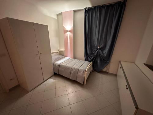 a small bedroom with a bed and a window at Well Home Country in Montemarciano