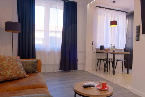 a living room with a couch and a table at Apartament e-Space in Rzeszów