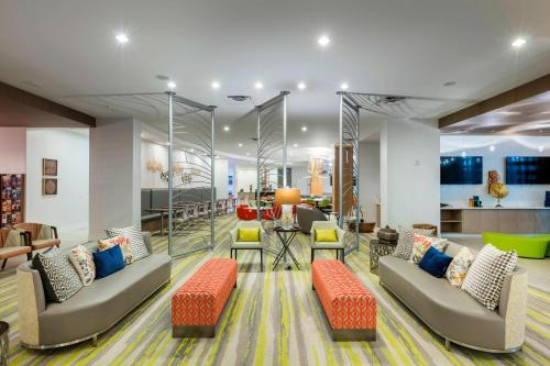 a living room with two couches and a kitchen at TownePlace Suites by Marriott Orlando at SeaWorld in Orlando