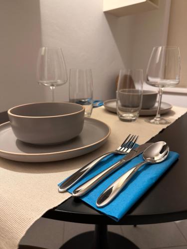 a table with a blue napkin and fork and spoon at Well Home Country in Montemarciano