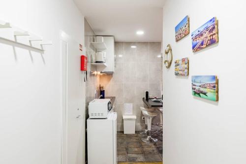 ポルトにあるSunny Oporto, Douro Apartmentsの小さなキッチン(白い冷蔵庫付)が備わる客室です。