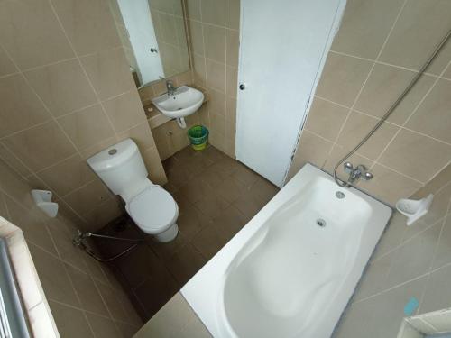 a small bathroom with a toilet and a sink at Taragon Suite at Kuala Lumpur in Kuala Lumpur