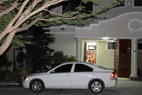 a white car parked in front of a house at Eagle Ridge Family Vacation House in General Trias