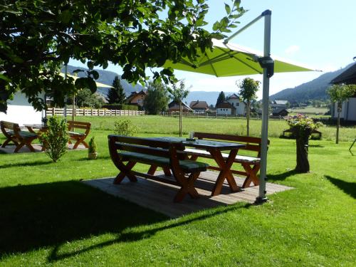 a picnic table and an umbrella in a park at Landhaus Lehner in Sankt Michael im Lungau
