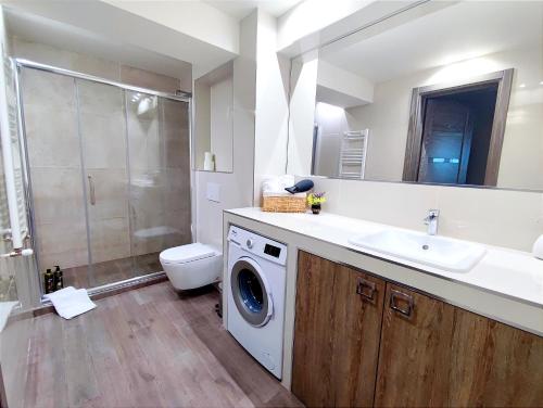 a bathroom with a sink and a washing machine at 2BR+living downtown Chișinău in Chişinău