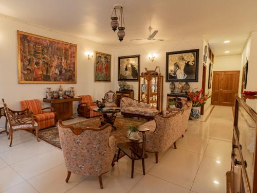 a living room with couches and a table and chairs at Anchorage 42 in Chandīgarh