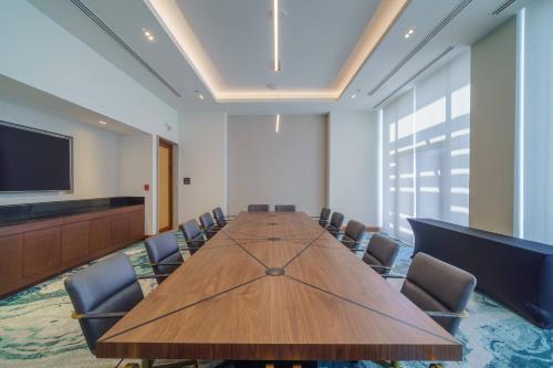 a conference room with a long wooden table and chairs at Renaissance Cancun Resort & Marina in Cancún