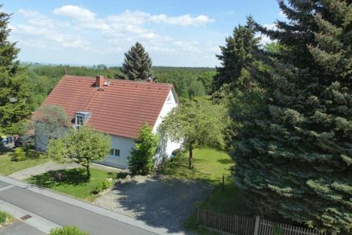 an aerial view of a house with a red roof at Urlaubsdomizil Am Töpfer - Ferienwohnungen in Olbersdorf in Olbersdorf