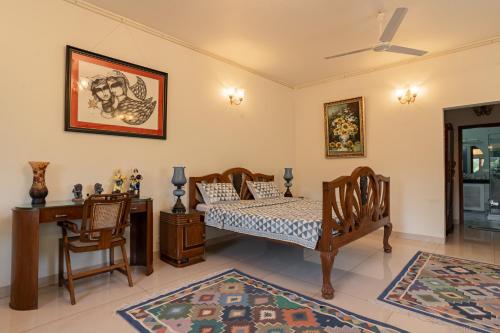 a bedroom with a bed and a desk and a chair at Anchorage 42 in Chandīgarh