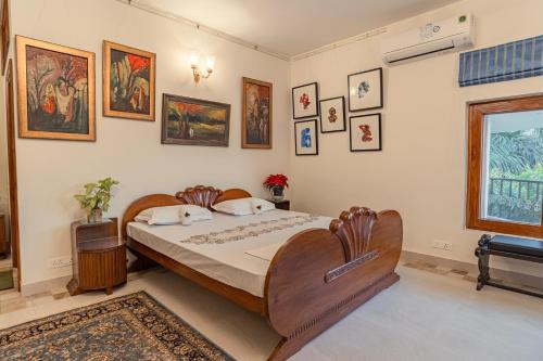 a bedroom with a bed and some pictures on the wall at Anchorage 42 in Chandīgarh