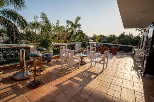 a patio with chairs and tables on a balcony at Anchorage 42 in Chandīgarh