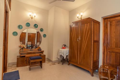 a bathroom with a wooden cabinet and a mirror at Anchorage 42 in Chandīgarh