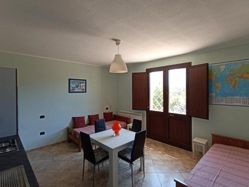 a living room with a table and a couch at Portoselvaggio Villa Martina in Santa Caterina di Nardò