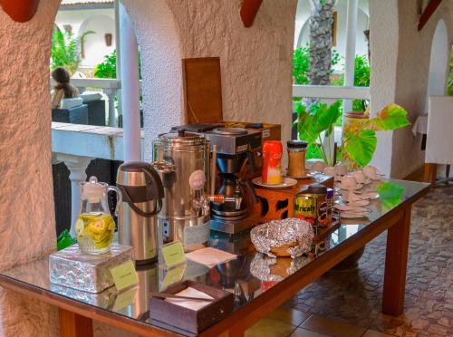 a glass table with a coffee maker on it at Best Western Jangwani Sea Breeze Resort in Dar es Salaam